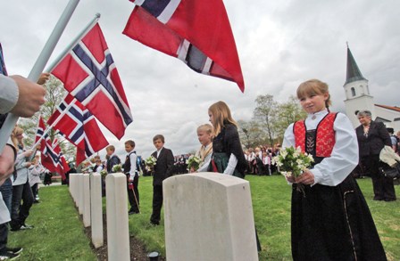 Schoolchildren in National Costume laid flowers on the war graves on Norways National Day.